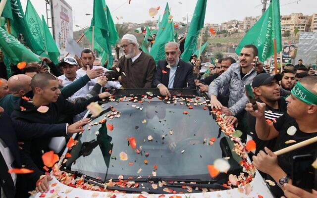 Sheikh Raed Salah (C-L), leader of the radical northern branch of the Islamic Movement in Israel, celebrates with supporters following his release from a jail in the Arab city of Umm al-Fahm in northern Israel on December 13, 2021. (Photo by AHMAD GHARABLI / AFP) Sheikh Raed Salah (C-L), leader of the radical northern branch of the Islamic Movement in Israel, celebrates with supporters following his release from a jail in the Arab city of Umm al-Fahm in northern Israel on December 13, 2021. (Photo by AHMAD GHARABLI / AFP)