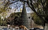 A giant Christmas tree is seen at outside the Church of the Nativity, in the West Bank city of Bethlehem, on December 15, 2021. (Abbas Momani/AFP)