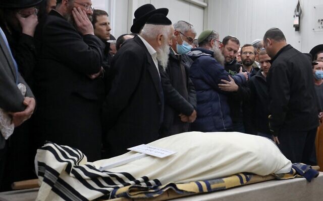 Mourners attend the funeral of Yehuda Dimentman, in Jerusalem, on December 17, 2021. Dimentman was shot dead in a December 16 terror attack. (GIL COHEN-MAGEN / AFP) Mourners attend the funeral of Yehuda Dimentman, in Jerusalem, on December 17, 2021. Dimentman was shot dead in a December 16 terror attack. (GIL COHEN-MAGEN / AFP)
