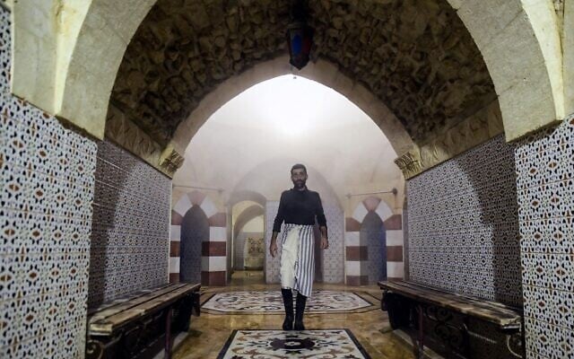 A man walks at Hammam al-Qawas, a traditional Turkish bathhouse, in Syria's northern city of Aleppo on December 16, 2021. (Photo by AFP)