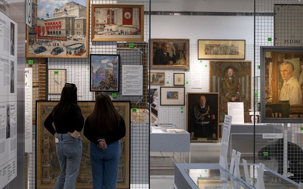 Visitors explores art works at an exhibition titled 'Vienna Falls in Line. The Politics of Art under National Socialism' showing Nazi artifacts at the city's Vienna Museum in Vienna, Austria, on November 9, 2021 (JOE KLAMAR / AFP)