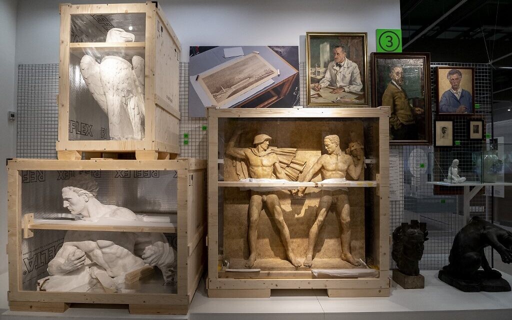 Art works are on display at an exhibition titled "Vienna Falls in Line. The Politics of Art under National Socialism" showing Nazi artifacts at the city's "Vienna Museum" in Vienna, Austria, on November 9, 2021. - From October 2021 until April 2022, the city "Vienna Museum" will be presenting in two small rooms the cumbersome legacy of a long-denied past: 
the exhibition, which is soberly entitled "Vienna is on the move", shows its stockpile of Nazi art, consisting of neoclassical sculptures and official paintings, without complacency. (Photo by JOE KLAMAR / AFP)