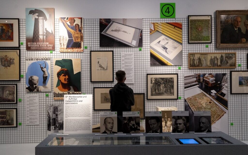A visitor explores art works at an exhibition titled 'Vienna Falls in Line. The Politics of Art under National Socialism' showing Nazi artifacts at the city's Vienna Museum in Vienna, Austria, on November 9, 2021 (JOE KLAMAR / AFP)