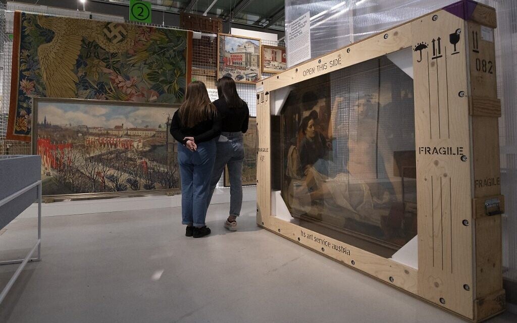 Visitors explores art works at an exhibition titled 'Vienna Falls in Line. The Politics of Art under National Socialism' showing Nazi artifacts at the city's Vienna Museum in Vienna, Austria, on November 9, 2021 (JOE KLAMAR / AFP)