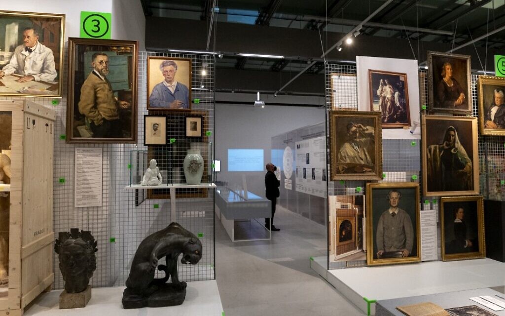 A visitor explores art works at an exhibition titled 'Vienna Falls in Line. The Politics of Art under National Socialism' showing Nazi artifacts at the city's Vienna Museum in Vienna, Austria, on November 9, 2021 (JOE KLAMAR / AFP)