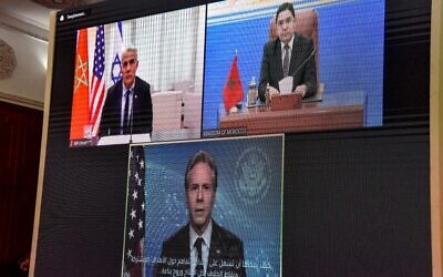 A picture taken in the office of Morocco's Foreign Minister Nasser Bourita's (top-R) in the capital Rabat, shows him and his counterparts Israel's Yair Lapid (top-L) and Antony Blinken  of the US (Bottom), take part in a virtual meeting, on December 22, 2021. (AFP)