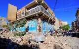 Yemenis inspect damage following a reported overnight air strike by the Saudi-led coalition targeting in the Houthi rebel-held capital Sanaa, on December 24, 2021. (MOHAMMED HUWAIS / AFP)