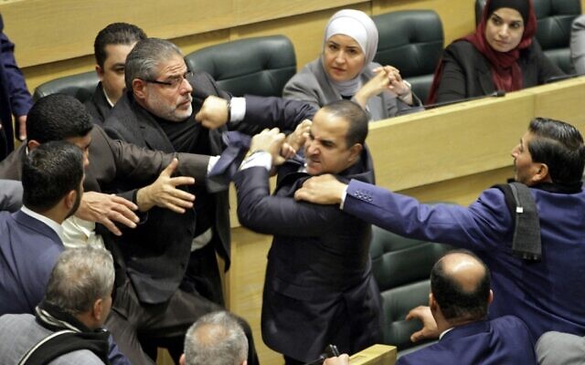 Jordanian parliament members are separated during an altercation in the parliament in the capital Amman on December 28, 2021. (Photo by AFP) Jordanian parliament members are separated during an altercation in the parliament in the capital Amman on December 28, 2021. (Photo by AFP)