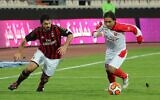 This file photo taken on November 28, 2013, shows former former Persepolis player Mehdi Mahdavikia (R) and former AC Milan player Gennaro Gattuso vying for the ball during an exhibition soccer match at the Azadi stadium in Tehran. (Photo by ATTA KENARE / AFP)