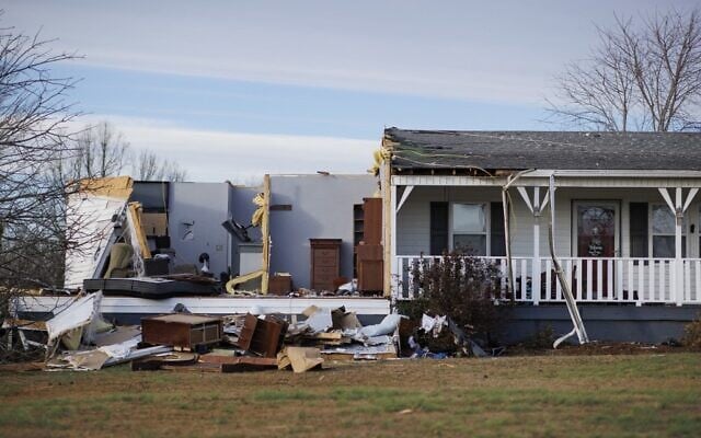 A home damaged by winds stands with some of the walls and roof missing after a tornado ripped through the area the previous evening in Mayfield, Kentucky, on December 11, 2021. (Brett Carlsen / GETTY IMAGES NORTH AMERICA / Getty Images via AFP)