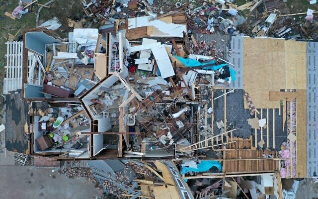An aerial view of debris scattered around a home destroyed by a tornado in Mayfield, Kentucky, on December 11, 2021. (SCOTT OLSON / GETTY IMAGES NORTH AMERICA / Getty Images via AFP)