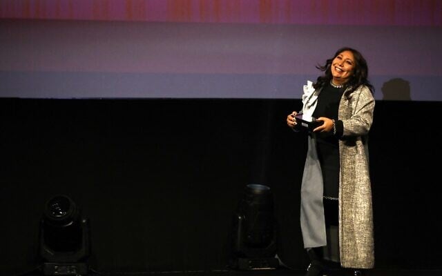 Saudi movie maker Haifaa al Mansour receives a honorary award during the opening of the first edition of the Red Sea Film Festival in the Saudi city of Jeddah, on December 6, 2021. (PATRICK BAZ / Red Sea Film Festival)