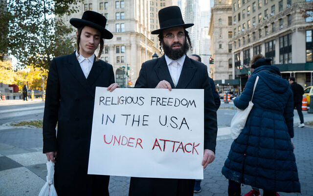 Ultra-Orthodox men protest COVID-19 vaccine requirements in New York City, November 11, 2021. (Luke Tress/Times of Israel) Ultra-Orthodox men protest COVID-19 vaccine requirements in New York City, November 11, 2021. (Luke Tress/Times of Israel)