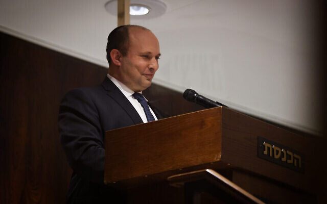 Prime Minister Naftali Bennett is seen in the isolation area of the Knesset chamber during a plenum session on December 27, 2021. (Knesset spokesperson) Prime Minister Naftali Bennett is seen in the isolation area of the Knesset chamber during a plenum session on December 27, 2021. (Knesset spokesperson)