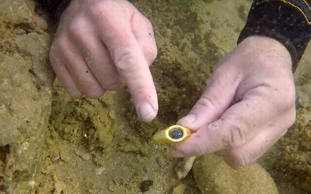 The underwater discovery of a gold ring engraved with the figure of the Good Shepherd. (Israel Antiquities Authority)