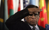 Then president of the United Nations Security Council and South Africa's deputy minister of International Relations and Cooperation Ebrahim Ismail Ebrahim shields his eyes from television lights during press briefing while the council breaks from a meeting on the Middle East, January 24, 2012. (AP Photo/Bebeto Matthews)