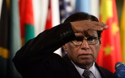 Then president of the United Nations Security Council and South Africa's deputy minister of International Relations and Cooperation Ebrahim Ismail Ebrahim shields his eyes from television lights during press briefing while the council breaks from a meeting on the Middle East, January 24, 2012. (AP Photo/Bebeto Matthews)