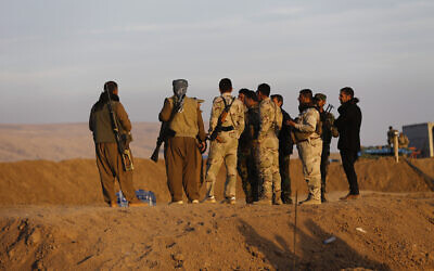 Illustrative - In this file photo taken on November 17, 2016, Kurdish Peshmerga fighters stand on a sand barrier created by Kurdish forces to demarcate their border, in the Nineveh plain, northeast of Mosul, Iraq. (AP Photo/Hussein Malla, File)