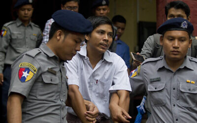 Reuters journalist Kyaw Soe Oo talks to reporters as he leave a court after his trial, on Monday, August 20, 2018, in Yangon, Myanmar. The reporter was accused of illegally possessing official information. (AP Photo/Thein Zaw)