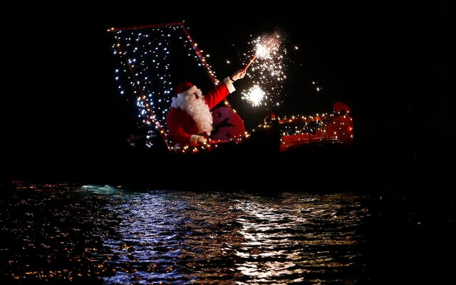 A man dressed as Santa Claus holds a flare as he sits on a boat during a Christmas eve celebrations in Imperia, Italy, Monday, Dec. 24, 2018. (AP Photo/Antonio Calanni) A man dressed as Santa Claus holds a flare as he sits on a boat during a Christmas eve celebrations in Imperia, Italy, Monday, Dec. 24, 2018. (AP Photo/Antonio Calanni)
