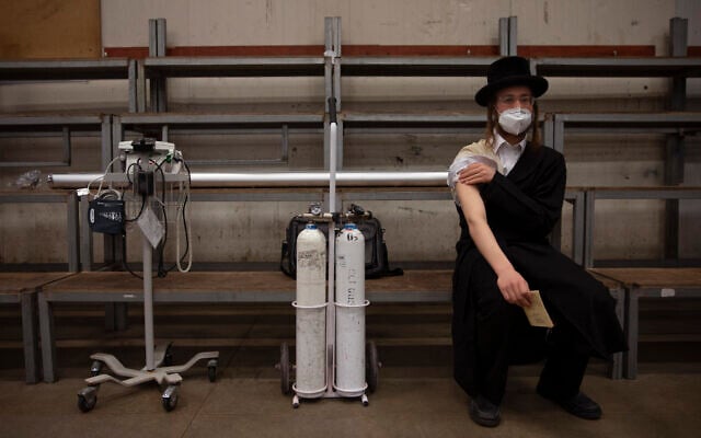 A man rests after receiving his second dose of the Pfizer COVID-19 vaccine at a coronavirus vaccination center set up at a synagogue in Bnei Brak, Israel, March. 7, 2021. (AP Photo/Oded Balilty) A man rests after receiving his second dose of the Pfizer COVID-19 vaccine at a coronavirus vaccination center set up at a synagogue in Bnei Brak, Israel, March. 7, 2021. (AP Photo/Oded Balilty)