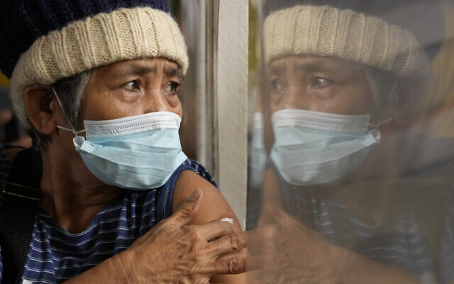 A woman holds onto a cotton pad after being inoculated with AstraZeneca's COVID-19 vaccine during the first day of a nationwide three-day vaccination drive at a school in Quezon city, Philippines on Nov. 29, 2021 (AP Photo/Aaron Favila) A woman holds onto a cotton pad after being inoculated with AstraZeneca's COVID-19 vaccine during the first day of a nationwide three-day vaccination drive at a school in Quezon city, Philippines on Nov. 29, 2021 (AP Photo/Aaron Favila)