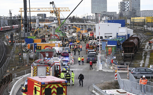 Firefighters, police officers and railway employees stand on a railway site in Munich, Germany, December 1, 2021. (Sven Hoppe/dpa via AP) Firefighters, police officers and railway employees stand on a railway site in Munich, Germany, December 1, 2021. (Sven Hoppe/dpa via AP)
