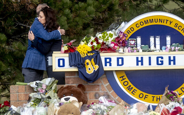 Gov. Gretchen Whitmer embraces Oakland County Executive Dave Coulter as the two leave flowers and pay their respects Thursday morning, Dec. 2, 2021 at Oxford High School in Oxford, Mich. (Jake May/The Flint Journal via AP) Gov. Gretchen Whitmer embraces Oakland County Executive Dave Coulter as the two leave flowers and pay their respects Thursday morning, Dec. 2, 2021 at Oxford High School in Oxford, Mich. (Jake May/The Flint Journal via AP)