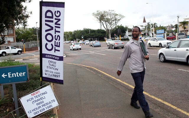 A man walks past a mobile COVID-19 testing station in Durban, South Africa, Dec.ember 3 2021. (AP Photo) A man walks past a mobile COVID-19 testing station in Durban, South Africa, Dec.ember 3 2021. (AP Photo)