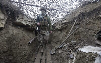 Ukrainian soldiers walks under a camouflage net in a trench on the line of separation from pro-Russian rebels near Debaltsevo, Donetsk region, Ukraine, Ukraine Friday, Dec 3, 2021 (AP Photo/Andriy Dubchak) Ukrainian soldiers walks under a camouflage net in a trench on the line of separation from pro-Russian rebels near Debaltsevo, Donetsk region, Ukraine, Ukraine Friday, Dec 3, 2021 (AP Photo/Andriy Dubchak)