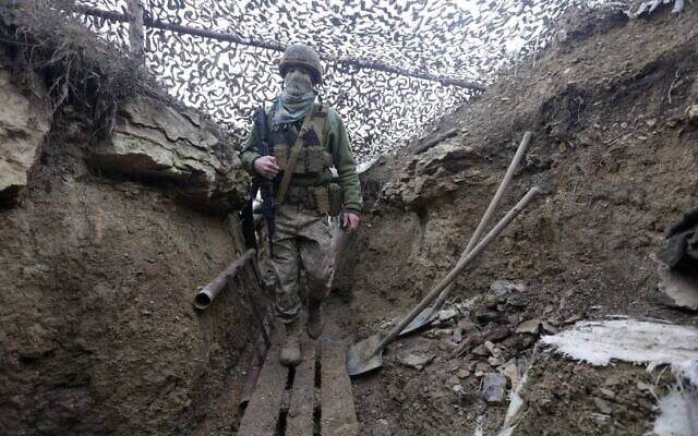 Ukrainian soldiers walks under a camouflage net in a trench on the line of separation from pro-Russian rebels near Debaltsevo, Donetsk region, Ukraine, Ukraine Friday, Dec 3, 2021 (AP Photo/Andriy Dubchak) Ukrainian soldiers walks under a camouflage net in a trench on the line of separation from pro-Russian rebels near Debaltsevo, Donetsk region, Ukraine, Ukraine Friday, Dec 3, 2021 (AP Photo/Andriy Dubchak)