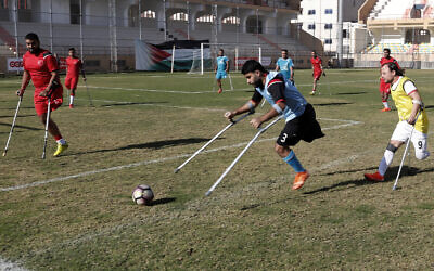 Palestinian amputees play a soccer match while using their crutches during a training session, at Palestine Stadium in Gaza City, Sunday, Dec. 5, 2021. (AP Photo/Adel Hana)