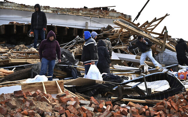 A family digs through the remains of their apartment in Mayfield, Kentucky, Saturday, Dec. 11, 2021. Tornadoes and severe weather caused catastrophic damage across multiple states late Friday, killing several people overnight. (AP Photo/Timothy D. Easley) A family digs through the remains of their apartment in Mayfield, Kentucky, Saturday, Dec. 11, 2021. Tornadoes and severe weather caused catastrophic damage across multiple states late Friday, killing several people overnight. (AP Photo/Timothy D. Easley)