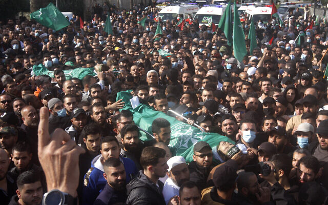 Palestinian mourners carry the bodies of two members of Hamas who were killed after gunfire erupted last Sunday during a Hamas-organized funeral in a Palestinian refugee camp, during their funeral procession in the southern port city of Sidon, Lebanon, on December 14, 2021. (AP Photo/Mohammed Zaatari) Palestinian mourners carry the bodies of two members of Hamas who were killed after gunfire erupted last Sunday during a Hamas-organized funeral in a Palestinian refugee camp, during their funeral procession in the southern port city of Sidon, Lebanon, on December 14, 2021. (AP Photo/Mohammed Zaatari)