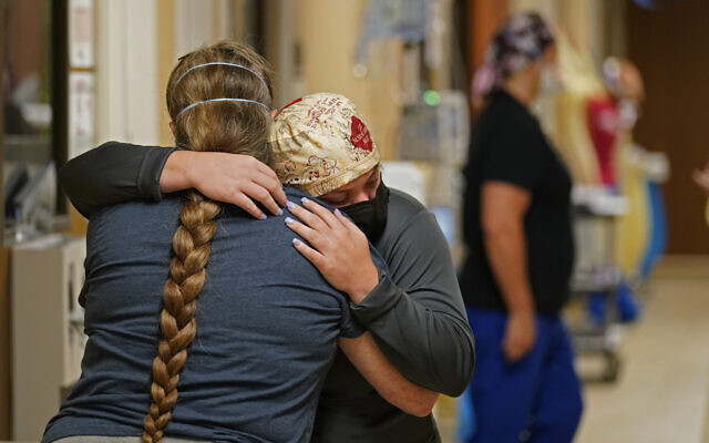 ICU nurse Melinda Hunt, facing, hugs the sister of a COVID-19 patient she had been caring for, who had just passed away, inside a COVID unit at the Willis-Knighton Medical Center in Shreveport, La., Aug. 18, 2021. (AP Photo/Gerald Herbert, File) ICU nurse Melinda Hunt, facing, hugs the sister of a COVID-19 patient she had been caring for, who had just passed away, inside a COVID unit at the Willis-Knighton Medical Center in Shreveport, La., Aug. 18, 2021. (AP Photo/Gerald Herbert, File)