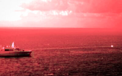 In this handout infrared photo from the US Marine Corps, the USS Portland fires a laser weapon system at a target floating in the Gulf of Aden on Tuesday, Dec. 14, 2021. (Staff Sgt. Donald Holbert/U.S. Marine Corps via AP)