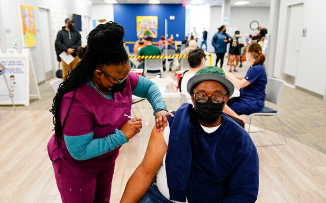 Nurse Sheena Davis administers a dose of a Moderna COVID-19 vaccine during a vaccination clinic at the Keystone First Wellness Center in Chester, Pennsylvania, Dec. 15, 2021. (AP Photo/Matt Rourke) Nurse Sheena Davis administers a dose of a Moderna COVID-19 vaccine during a vaccination clinic at the Keystone First Wellness Center in Chester, Pennsylvania, Dec. 15, 2021. (AP Photo/Matt Rourke)