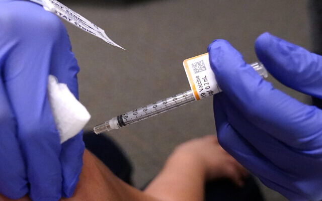 An eight-year-old child receives a second dose of the Pfizer COVID-19 vaccine at Northwest Community Church in Chicago, December 11, 2021. (AP Photo/Nam Y. Huh) An eight-year-old child receives a second dose of the Pfizer COVID-19 vaccine at Northwest Community Church in Chicago, December 11, 2021. (AP Photo/Nam Y. Huh)