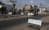 Members of Palestinian Hamas police stand guard at a checkpoint in Gaza City, Thursday, Nov. 25, 2021. (AP Photo/ Khalil Hamra)