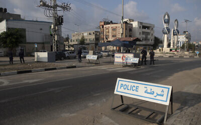 Members of Palestinian Hamas police stand guard at a checkpoint in Gaza City, Thursday, Nov. 25, 2021. (AP Photo/ Khalil Hamra)