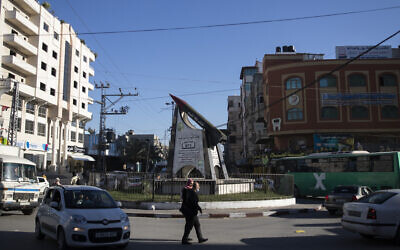 Palestinians walk past monument to a Kassam rocket in Gaza City, Wednesday, Dec. 15, 2021.  (AP Photo/ Khalil Hamra)