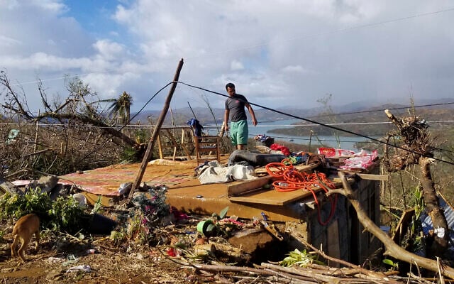 A man checks his damaged home due to Typhoon Rai at Dinagat islands, southern Philippines on December 19, 2021. The death toll continues to rise following the strongest typhoon to batter the Philippines this year, with several central towns and provinces still grappling with downed communications and power outages and pleading for food and water, officials said Monday. (Office of the Vice President via AP) A man checks his damaged home due to Typhoon Rai at Dinagat islands, southern Philippines on December 19, 2021. The death toll continues to rise following the strongest typhoon to batter the Philippines this year, with several central towns and provinces still grappling with downed communications and power outages and pleading for food and water, officials said Monday. (Office of the Vice President via AP)
