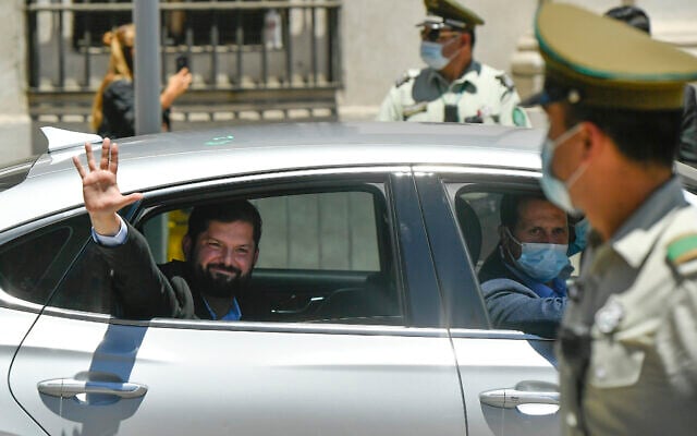 Chilean President-elect Gabriel Boric waves to supporters as he arrives to La Moneda presidential palace for a meeting with President Sebastian Pinera in Santiago, Chile, December 20, 2021. (AP Photo/ Matias Delacroix) Chilean President-elect Gabriel Boric waves to supporters as he arrives to La Moneda presidential palace for a meeting with President Sebastian Pinera in Santiago, Chile, December 20, 2021. (AP Photo/ Matias Delacroix)