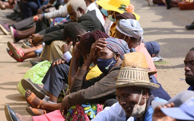 Elderly people, many without face masks or not fitted properly, sit in tightly packed lines waiting to withdraw their pensions in Harare, Zimbabwe on December 13, 2021. (AP Photo/ Tsvangirayi Mukwazhi) Elderly people, many without face masks or not fitted properly, sit in tightly packed lines waiting to withdraw their pensions in Harare, Zimbabwe on December 13, 2021. (AP Photo/ Tsvangirayi Mukwazhi)