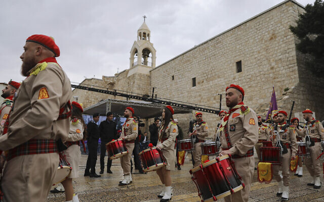 Palestinian scout band members parade through Manger Square at the Church of the Nativity in Bethlehem, Dec. 24, 2021 (Mahmoud Illean/AP) Palestinian scout band members parade through Manger Square at the Church of the Nativity in Bethlehem, Dec. 24, 2021 (Mahmoud Illean/AP)