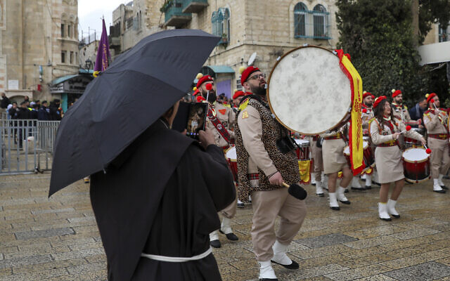 Palestinian scout bands parade through Manger Square at the Church of the Nativity during Christmas celebrations in Bethlehem, Dec. 24, 2021 (AP Photo/Mahmoud Illean) Palestinian scout bands parade through Manger Square at the Church of the Nativity during Christmas celebrations in Bethlehem, Dec. 24, 2021 (AP Photo/Mahmoud Illean)
