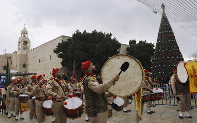 Palestinian scout band members parade through Manger Square at the Church of the Nativity in Bethlehem, Dec. 24, 2021 (Mahmoud Illean/AP)