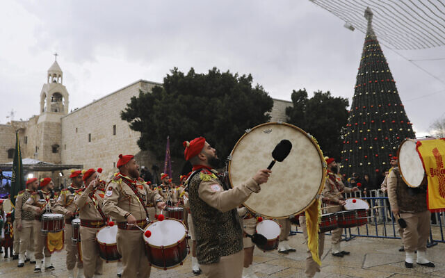 Palestinian scout band members parade through Manger Square at the Church of the Nativity in Bethlehem, Dec. 24, 2021 (Mahmoud Illean/AP) Palestinian scout band members parade through Manger Square at the Church of the Nativity in Bethlehem, Dec. 24, 2021 (Mahmoud Illean/AP)