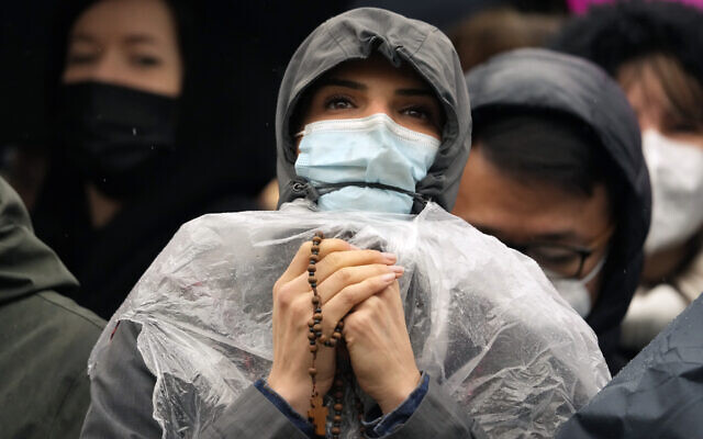 A woman holding a rosary waits for Pope Francis to deliver the Urbi et Orbi (Latin for 'to the city and to the world' ) Christmas day blessing from the main balcony of St. Peter's Basilica at the Vatican, December 25, 2021. (AP Photo/Gregorio Borgia) A woman holding a rosary waits for Pope Francis to deliver the Urbi et Orbi (Latin for 'to the city and to the world' ) Christmas day blessing from the main balcony of St. Peter's Basilica at the Vatican, December 25, 2021. (AP Photo/Gregorio Borgia)