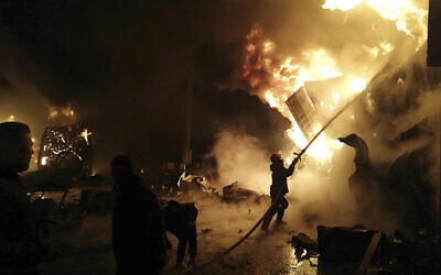 In this photo released by the Syrian official news agency SANA, firefighters work at the scene of a missile attack, at the port of the coastal city of Latakia, Syria, Tuesday, Dec. 28, 2021.  (SANA via AP)